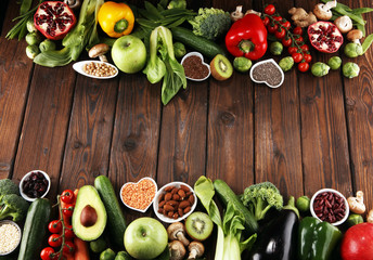 Healthy food clean eating selection. fruit, vegetable, seeds, superfood, cereals, leaf vegetable on rustic background