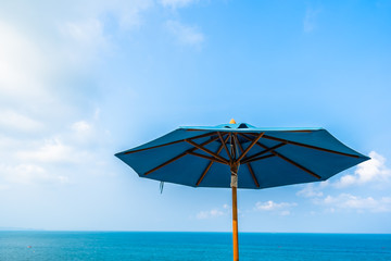 Blue color of umbrella with cloud sky and sea ocean