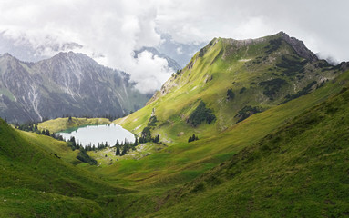 Fototapeta na wymiar Alp Mountain Lake and Green Valley