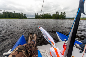 Four-seater catamaran on the bank of the river Vuoksa in Russia