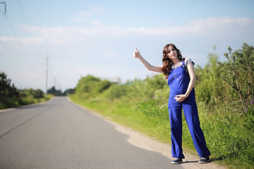 Pregnant woman on the road stops the car