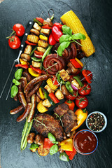 Assorted delicious grilled meat and skewer with vegetable on rustic table