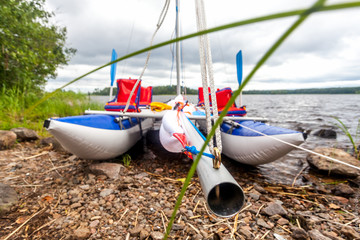 Four-seater catamaran on the bank of the river Vuoksa in Russia