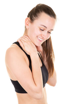 Female sport girl trainer with slim body in sport clothes keeping hands on neck isolated over white wall