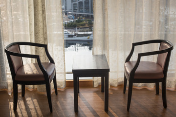 Classical hotel room interior of a table and chairs