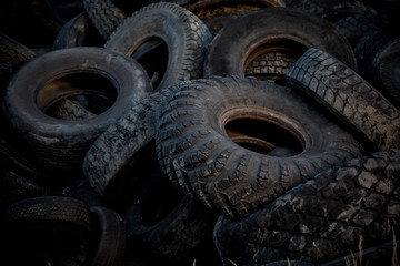 Old tyres polluting the nature. Environmental pollution.