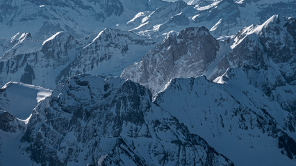 Stunning close up aerial views of the snow covered high mountain peaks of central Switzerland....