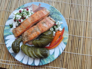 grilled salmon steak with vegetables on plate