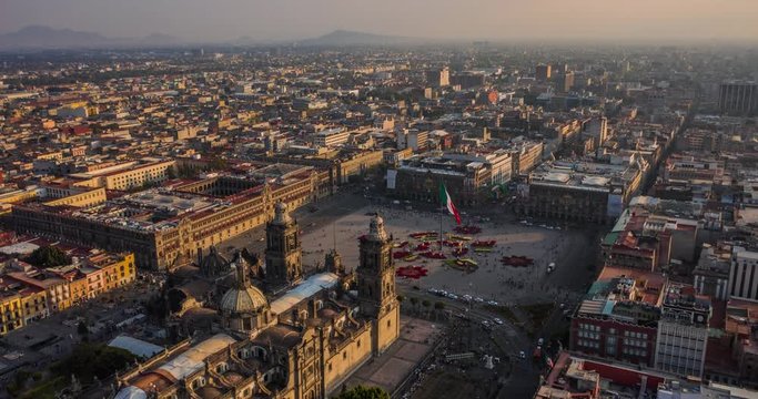 Aerial hyperlapse of the main plaza of Mexico City know as El Zocalo with Christmas decoration and the mexican flag.