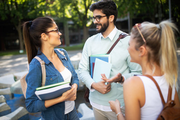 Happy group of friends studying and talking together at university