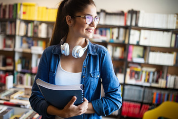 Beautiful student girl learning in a library