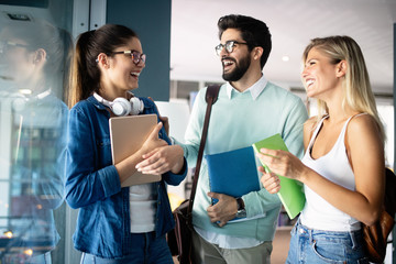 Happy group of students studying and learning together in college