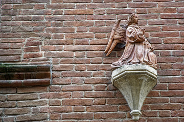 Medieval sculptures on Wall, decorated building with mythical creatures.