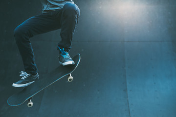 Skateboarding lifestyle. Extreme sport hobby. Freestyle. Man performing ramp trick. Skate park area light. Copy space. © golubovy