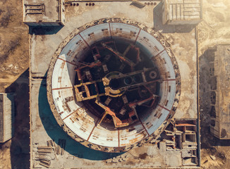 Fototapeta na wymiar Aerial top down view of abandoned and ruined Nuclear Power Plant in Shelkino, Crimea. Large USSR industrial construction with round tower of atomic reactor