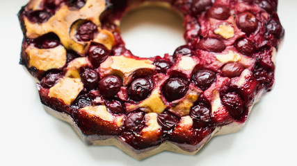 Delicious homemade organic cherry pie on a white background.
