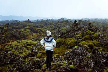 Fototapeta na wymiar Woman enjoying lava field view in Iceland