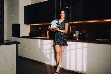 woman posing in loft with cake