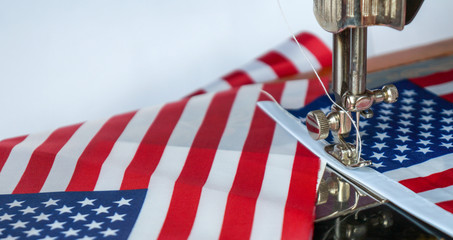 Sewing american flags. Preparation for celebrating 4 th of july