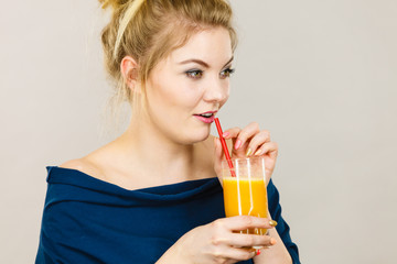 Happy woman holding fresh orange juice