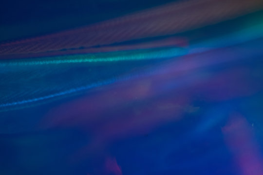 Defocused blue light waves. Blurry abstract background. Soft lens flare glow effect.