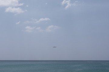 Fototapeta na wymiar Airplane Landing over sea at Phuket Airport, Mai Khao beach phuket thailand