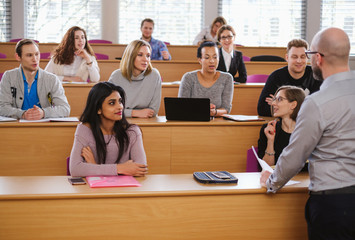 Lecturer and multinational group of students in an auditorium