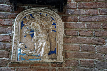 Medieval sculptures on Wall, decorated building with mythical creatures.