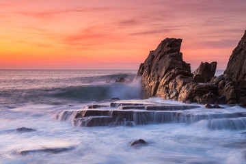 amazing sunset landscape at rocky beach	