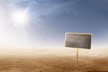 Views of desert with sunlight and little blackboard plank for copyspace