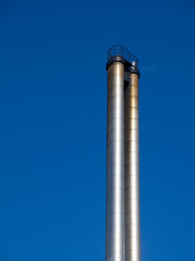 metal chimney in front of a blue sky