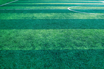 Artificial green grass soccer field background