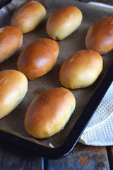Pies with cabbage and eggs. Baked stuffed patties on metal plate.