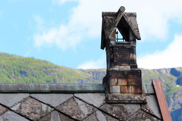 Fototapeta na wymiar Chimney on a stone church roof, Norway