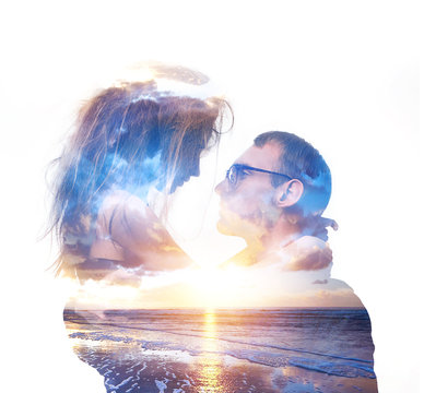 Double exposure portrait of hugging couple with ocean and sunset sky. Romance and people concept. Unity human and nature