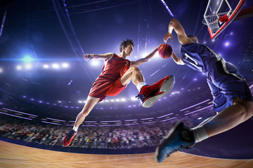Basketball player make block shot in jump. around Arena with blue light spot