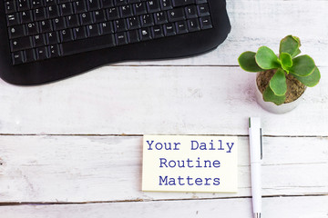Handwriting text writing Your Daily Routine Matters on stiky note