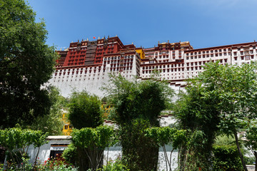 LHASA, TIBET / CHINA - July 31, 2017: Close up of main building of Potala Palace with trees and...