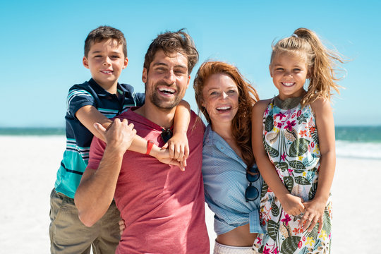 Happy Family Smiling At Beach