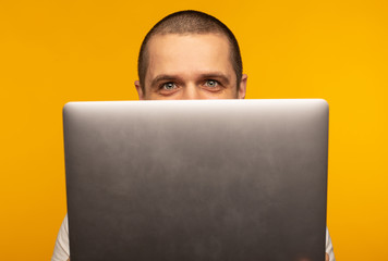 Half of head of man freelancer or programmer looking from laptop