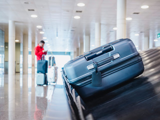 Suitcase or luggage on Baggage conveyor belt Airport Arrival hall People waiting