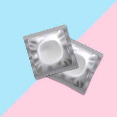 Condoms on blue and pink background.
