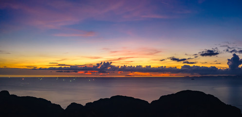 twilight seascape blue sky over colourful and silhouette mountain foreground at phi phi island...