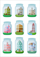 Decorative houses in glass jar on white background.