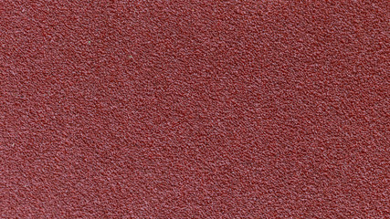 Red sandpaper texture background for industrial construction concept design.
