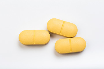 set of yellow tablets  on a white background
