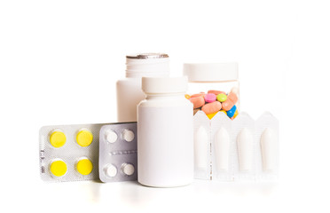 Different medical bottles and tablets isolated on white