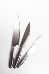 Set of steel kitchen knives on white background