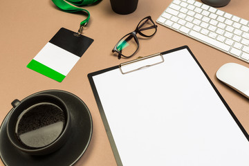 office desk table with  clipboard keyboard glasses succulent badge and coffee cup. Mock up template . Top view.