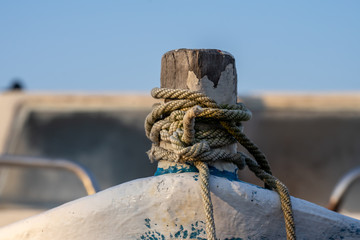 Wooden boat bow. Ropes on a wooden fishing boat. 